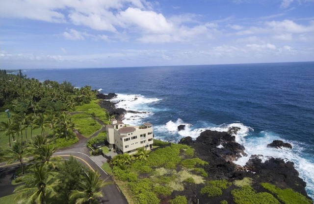 Luxury oceanfront property with crashing waves and coastline views for miles