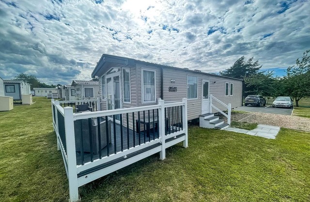 Modern caravan at Caldecott Hall with decking in Norfolk, sleeps 8 ref 91068C