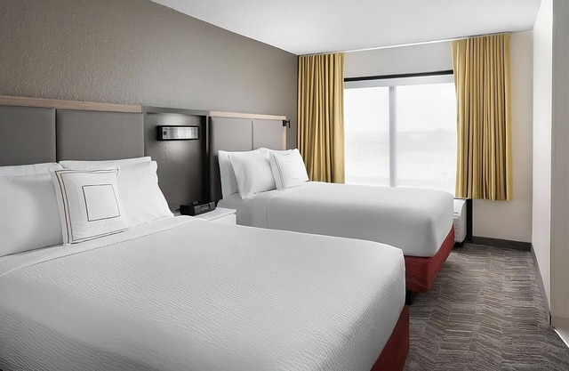 Modern Houston Room Offering Microwave, Shuttle Service & Inviting Pool Area