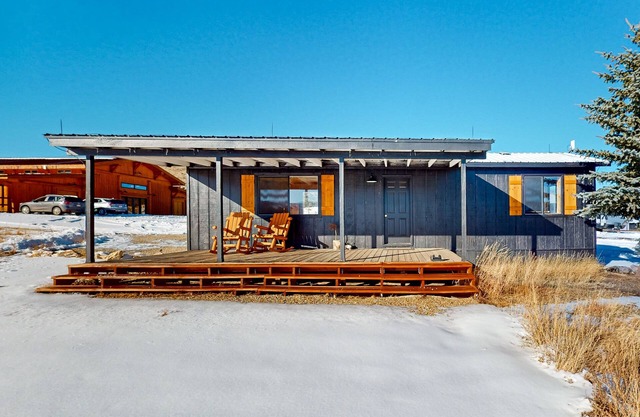 Mountain-view retreat on 1,800-acre ranch with animals, firepit, games, & deck