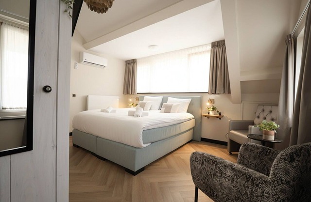 Newly renovated 1920 building with queen hotel bed, patio, and shared kitchen.