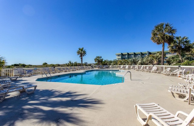 Oceanfront condo with water views, pool, balcony, & easy beach access