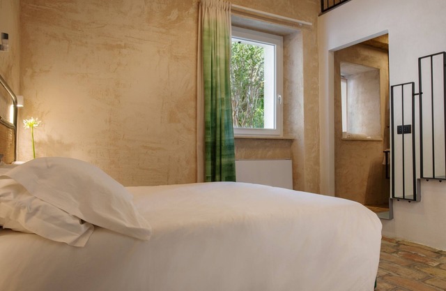 OGNISSANTI GUESTHOUSE,MARCHE REGION'S Double room with bathroom and a mezzanine with two single beds