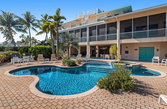 Opulent waterfront estate with dock, pool, hot tub & rooftop view - dog-friendly