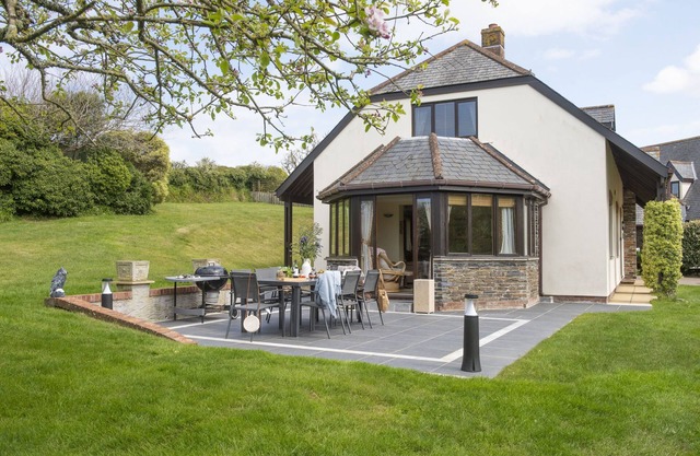 Overlooking the lakes of Roserrow, April Cottage is in an enviable location.
