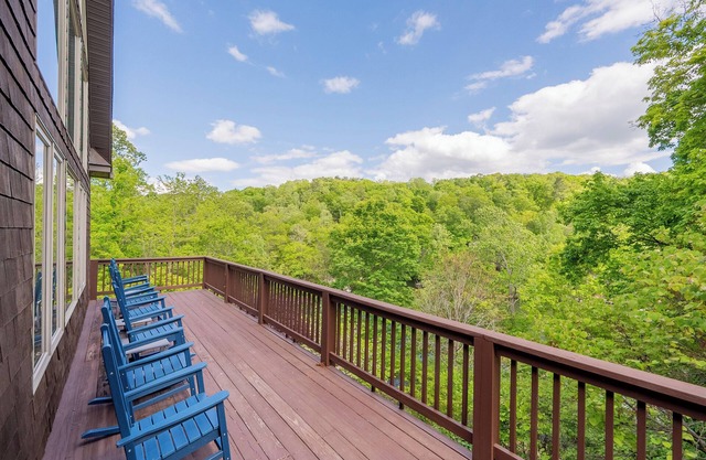 Private lakefront home with dock, forest views, balconies, game room, and cozy indoor charm