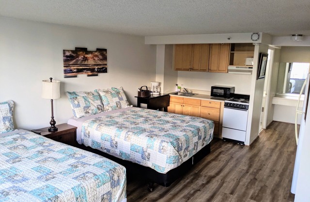 renovated studio room with two queen beds, full kitchen and full bath