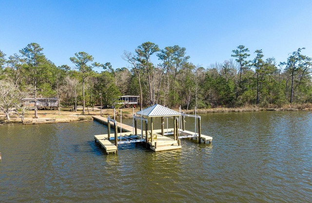 Secluded waterfront fishing cabin, boat dock, pier, sunsets, boat to beach