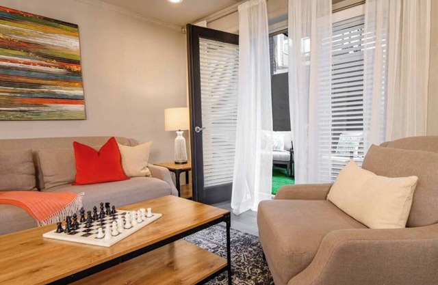 Sophisticated 2-bed, 1.5-bath furnished condo in central Dallas featuring a private patio, tranquil garden views, and exclusive access to an award-winning courtyard with spa-inspired wellness amenities, relaxing lounge areas, and resort-style pool.