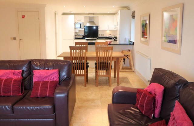 Spacious dog friendly apartment by the beach, private garden and sea views.