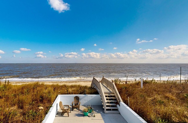 Sprawling beachfront home with alfresco dining, grill, games, W/D, & open layout