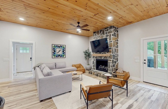 Stunning dog-friendly cottage with riverfront patio, hot tub, fire pit, & views
