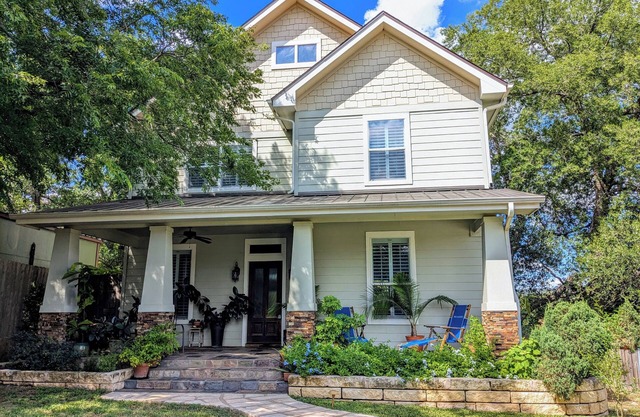 Welcoming home overlooking lake with forested hill country views
