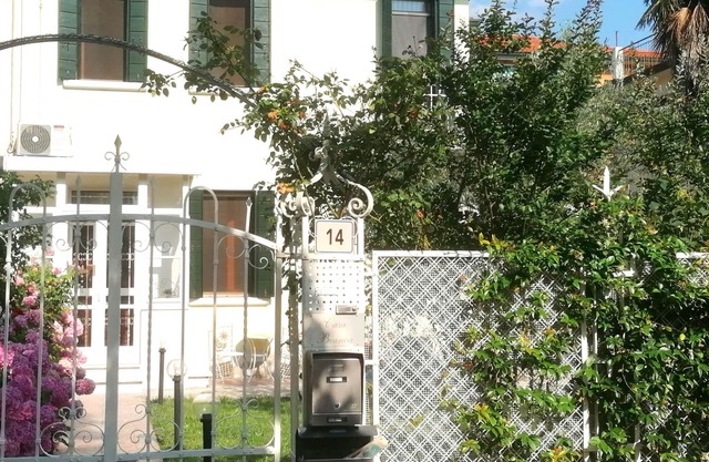 White house with garden and parking