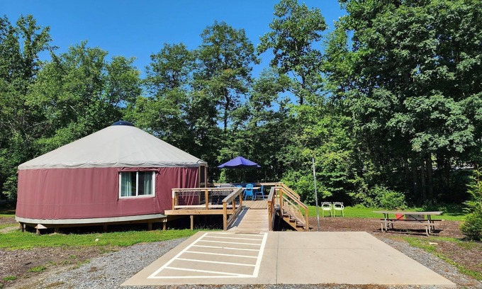 Mill Spring House | 30' ADA Yurt with a large deck, on the creek, full kitchen, dome skylight, dog friendly, 2 bedrooms, sleeps 5.