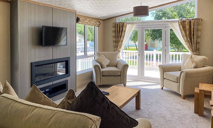 Langham House | A stunning lodge with one master double with en suite with bath and overhead shower.