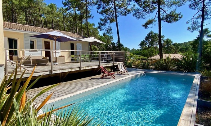 Lacanau-Ocean House | Amazing villa with pool and golf views, spacious pool area with wooded deck