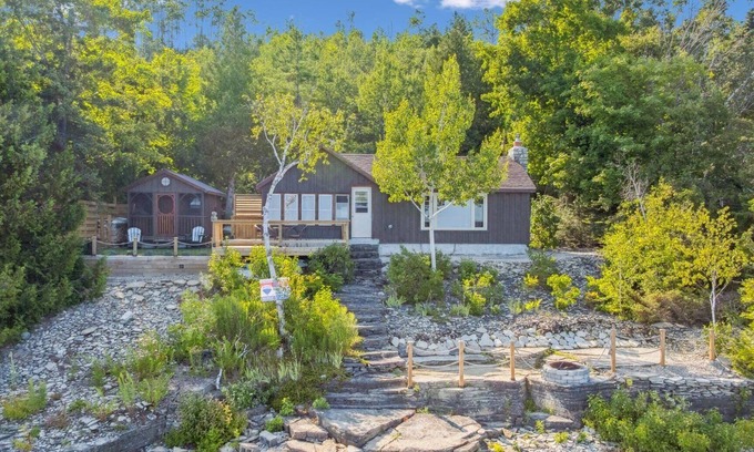 Dyer's Bay House | Cedar & Stone is a TICO licenced serene waterfront escape in exclusive Dyers Bay. Nestled between Georgian Bay and the Niagara Escarpment, this stylishly renovated cottage offers peaceful mornings, cozy evenings, and nature right at your doorstep.