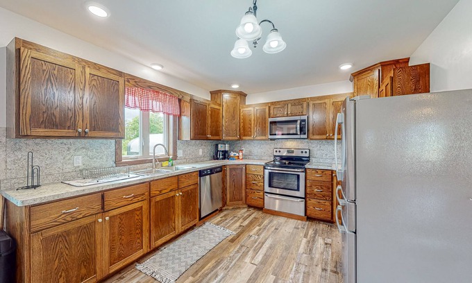 Town of Milo House | Charming 2-story dog-friendly farmhouse with game room, firepit, deck, grill
