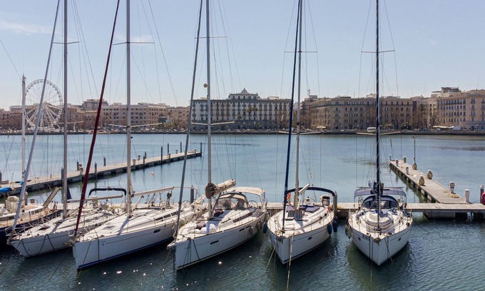 Bari City Centre Boat Rental | Charming sailing boat - in front of the city skyline