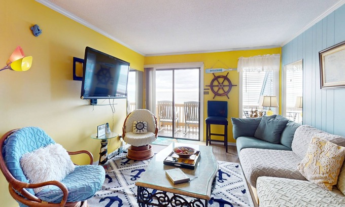 Ocean Isle Beach Condo | Colorful ocean view condo with pool, central AC, & private washer/dryer