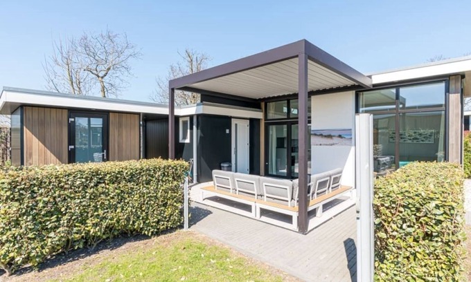 Burgh-Haamstede House | Discover this beautiful L-shaped chalet with a covered, sheltered terrace and a lovely lounge set. T