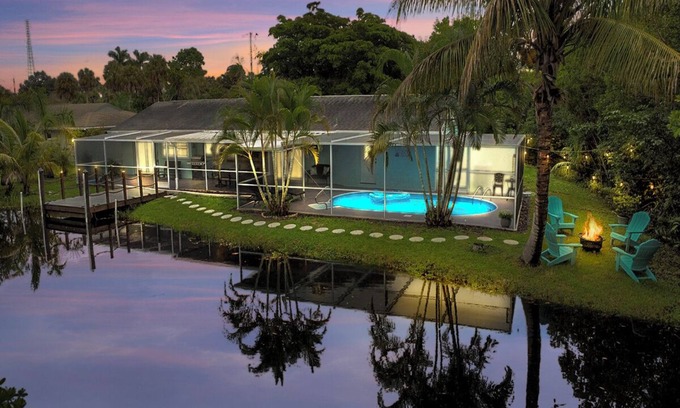 Fort Myers House | Enjoy a stunning waterfront view, pool table,kayaks, fishing, BBQ, heated & pool