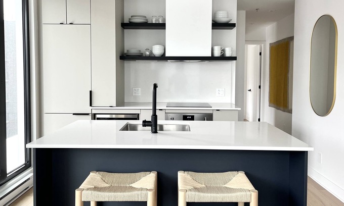 Griffintown Condo | French-scandi canal living: EV/bike parking, gym, pools, rooftop, $133 USD/night
