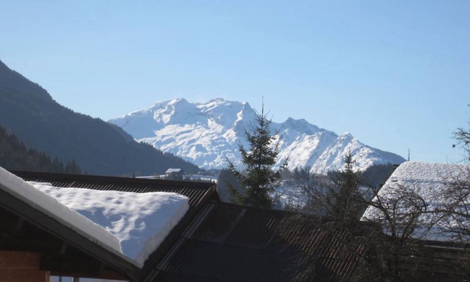 Le Grand-Bornand Apartment | Garden level with south-facing terrace and view of the Aravis massif