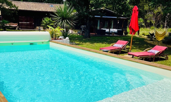 Hourtin Bed & Breakfast | LA CABANE" room with heated pool and forest view.