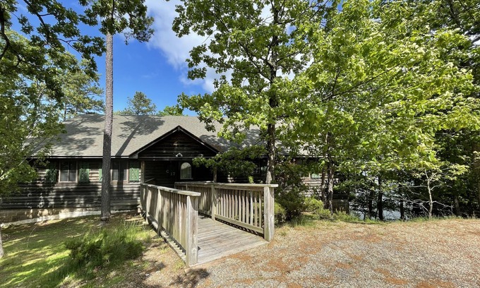 Mount Ida Cottage | Lake view three bedroom, three bath log-sided cottage with private hot tub overlooking Lake Ouachita. by RedAwning