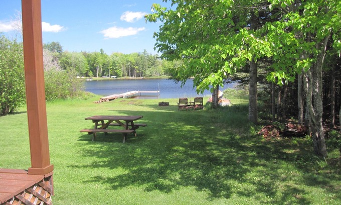 Wetmore Cottage | Lakefront, covered deck, huge backyard with grill, swimming, boat & kayaks!
