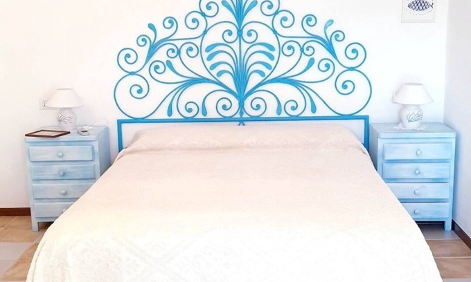 Baja Sardinia Apartment | Large and beautiful master bedroom with bathroom within walking distance of the sea.