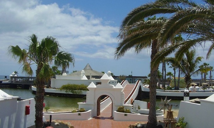 Costa Teguise Apartment | Luxury beachside villa with stunning sea views. Seven pools on complex!