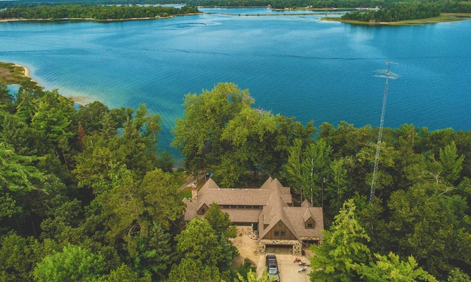 Nevis House | Luxury Lake Belle Taine retreat with private beach, sauna & four-season fun.