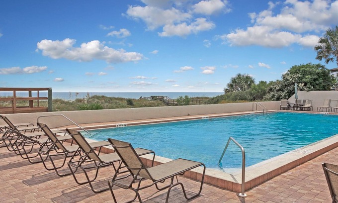 Crescent Beach Condo | Ocean Front Condo With Heated Pool outdoor patio overlooking the Ocean