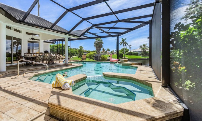 Pelican House | Riverfront Luxury with Heated Pool, Spa & Private Dock – Sunny Shores Escape