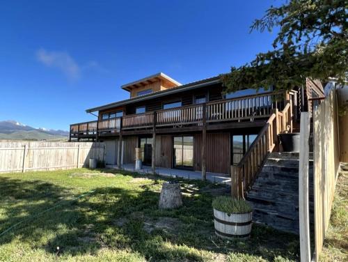 Ennis House | Scenic Vacation Home with Wrap-Around Deck Overlooking Ennis Lake near McAllister, Montana