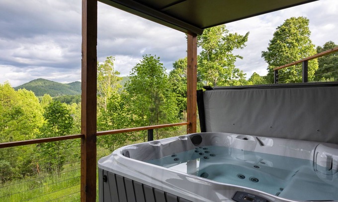 Young Harris Cabin | Skip’s Hideaway is a 4BR/3.5BA retreat for 10 in the North Georgia mountains. Enjoy fiery fall views, a private hot tub, gas fireplace, game room, and fenced yard for dogs. Perfect for cozy nights, family fun, and leaf-filled adventures.