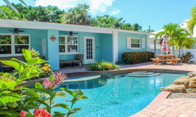 Holmes Beach Villa | Steps to the Beach with Shared Heated Salt Pool and Private Backyard & Grill