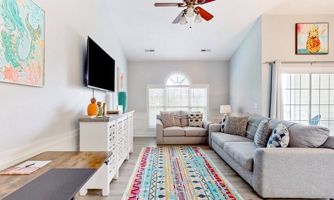 Little River Condo | Sunny condo with pool access, coastal theme, balcony, W/D, and central AC