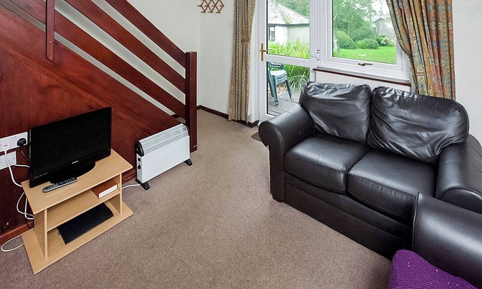 Chysauster Cottage | This silver cottage features an open kitchen, dining room, and living room.