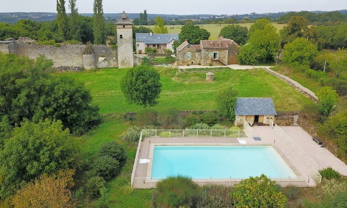 Ginals House | Two houses with a large swimming pool next to the ruins of a medieval castle