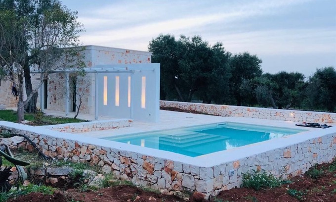 Ostuni Villa | White stone typical apulian villa with barrel roof surrounded by olive trees.