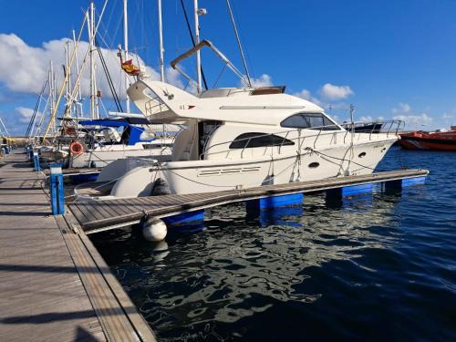 Santa Cruz de Tenerife Boat Rental | Yacht Experience Tenerife 24h plus Tour with private Skipper & private Hostess all inclusive with Cocktails, Sandwiches, free Minibar and free islandwide pick-up and return in a Tesla S Sportscar