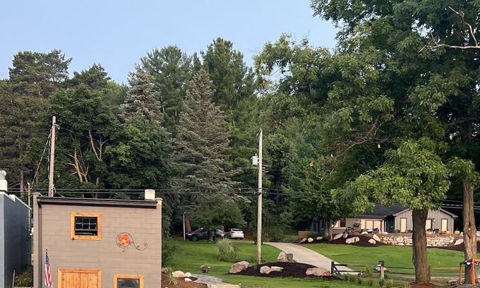 Rapid City House | 50 feet of Torch Lake frontage! Boathouse, beautiful patios sweet little beach.